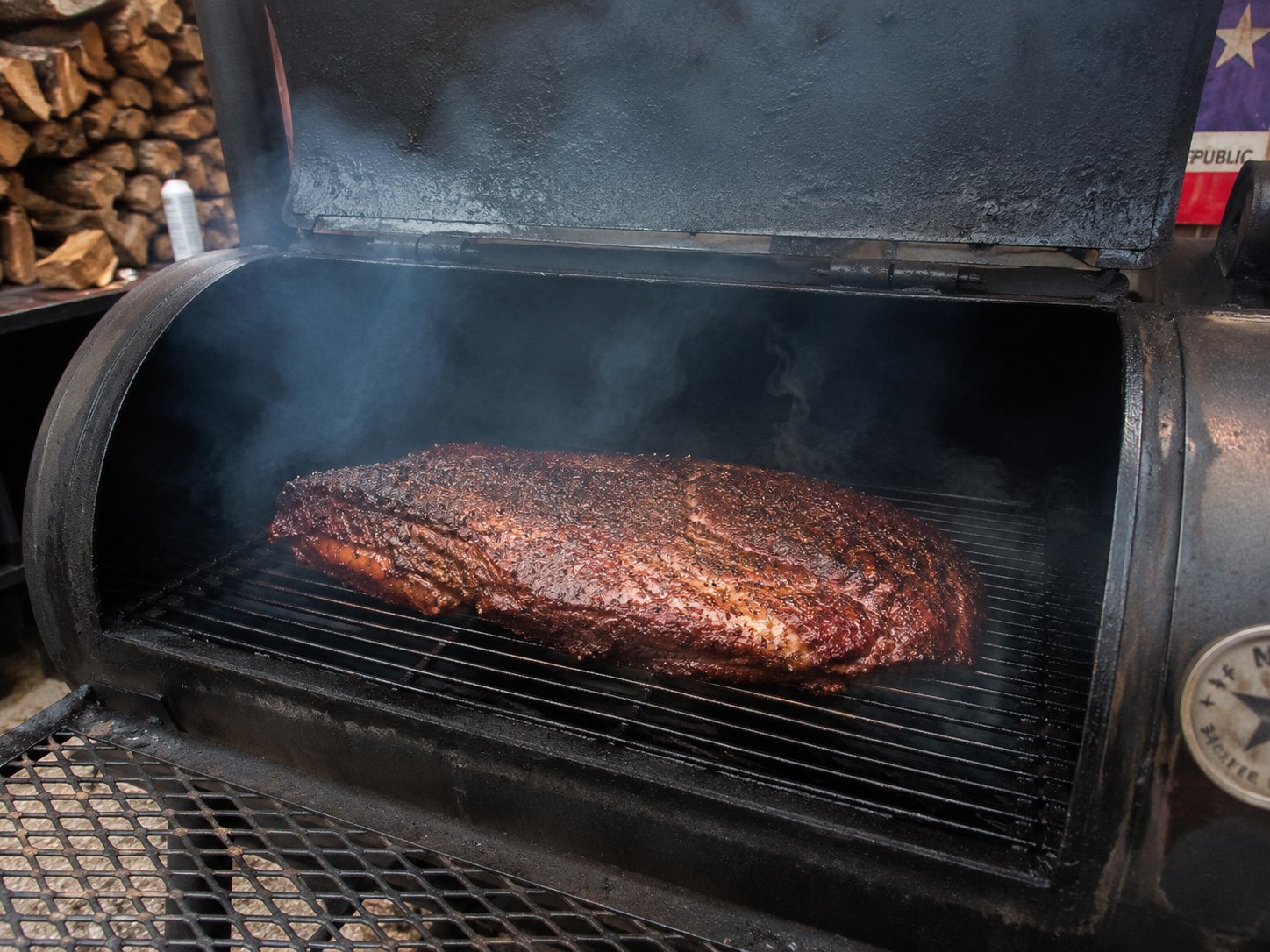 Brisket inside the smoker chamber developing a deep bark